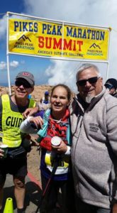 Mark, Dad (Doug), and Jessica at the Pikes Peak Marathon Summit sign.